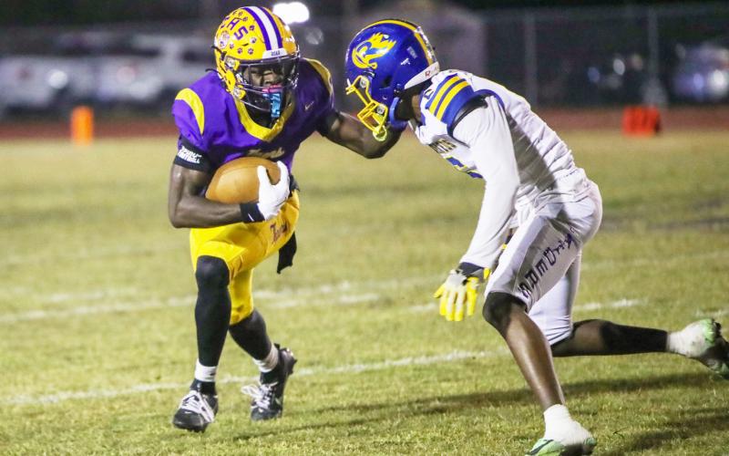 Columbia receiver Kyren Caldwell fights off a Rickards defender during last Friday’s Region 1-4A quarterfinal. (BRENT KUYKENDALL/Lake City Reporter)