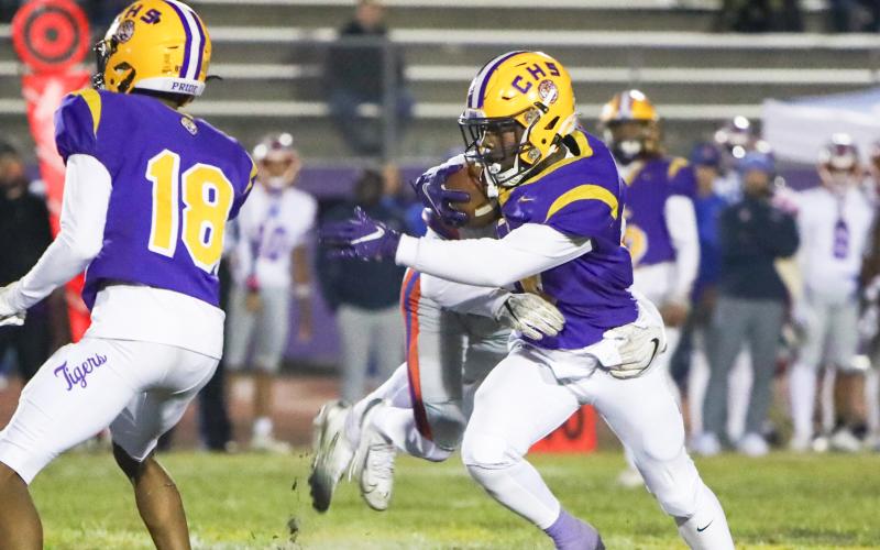 Columbia quarterback Xavier Collins tries to escape a Bolles’ tackler during Friday’s 31-0 loss. (BRENT KUYKENDALL/Lake City Reporter)