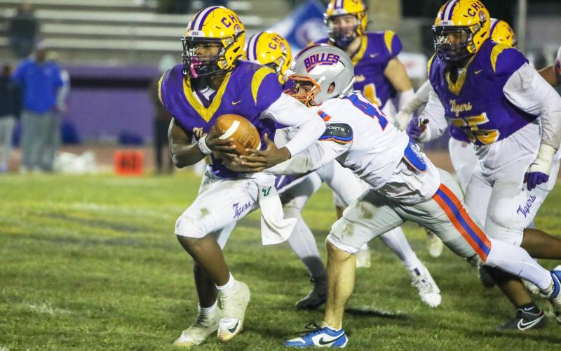 Columbia quarterback Xavier Collins tries to escape pressure from the Bolles defense on Oct. 31. (BRENT KUYKENDALL/Lake City Reporter)