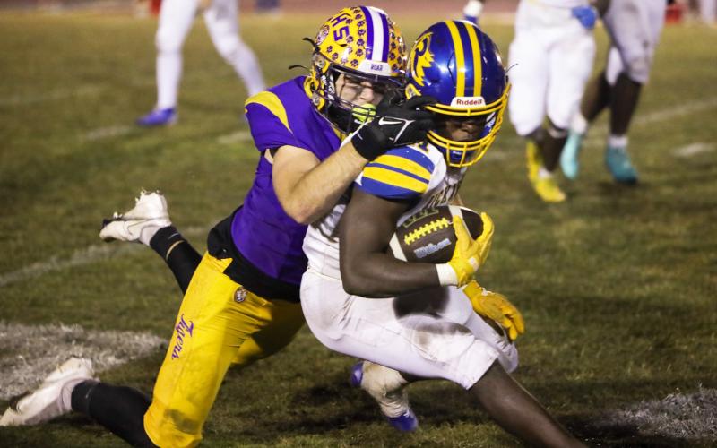 Columbia defensive end Kyten Davis tackles Rickards running back Karlise Price during last Friday’s Region 1-4A quarterfinal. (BRENT KUYKENDALL/Lake City Reporter)