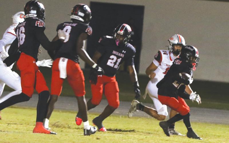 Fort White defensive back Mason Butler returns an interception against Baker County on Oct. 31. (MORGAN MCMULLEN/Lake City Reporter)