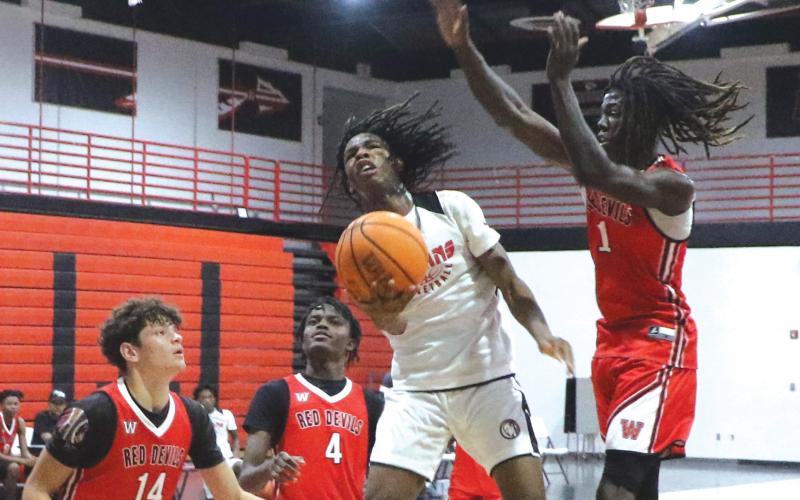 Fort White guard Tylan James goes airborne for a layup attempt against Williston during the Indians’ summer league opener in June. (FILE)