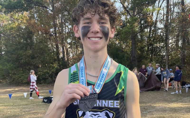 Suwannee runner Logan Haley shows off his state medal after placing 11th at the Class 2A state meet on Saturday. (COURTESY)