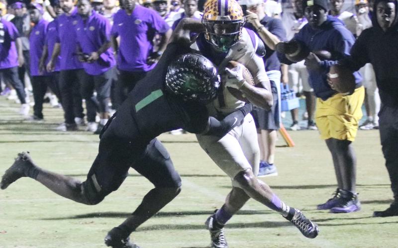 Columbia running back Kameron Mills is stopped by Choctaw safety Alante Reese two yards short of the first down on 4th-and-4 in the final minute of Friday's Region 1-4A semifinal. (JORDAN KROEGER/Lake City Reporter)