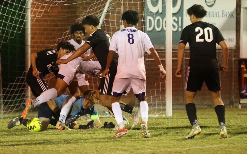 Columbia's defense corrals the ball to clear it away after goalkeeper Logan Wheeldon made a save during Wednesday's win over Suwannee. (PAUL BUCHANAN/Lake City Reporter)