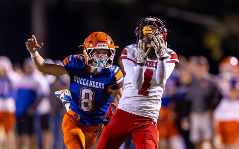 Lafayette receiver Kaeden Woods catches a pass in front of Branford defensive back Tripp Schultz on Oct. 24. (JACK HOWDESHELL/Lake City Reporter)