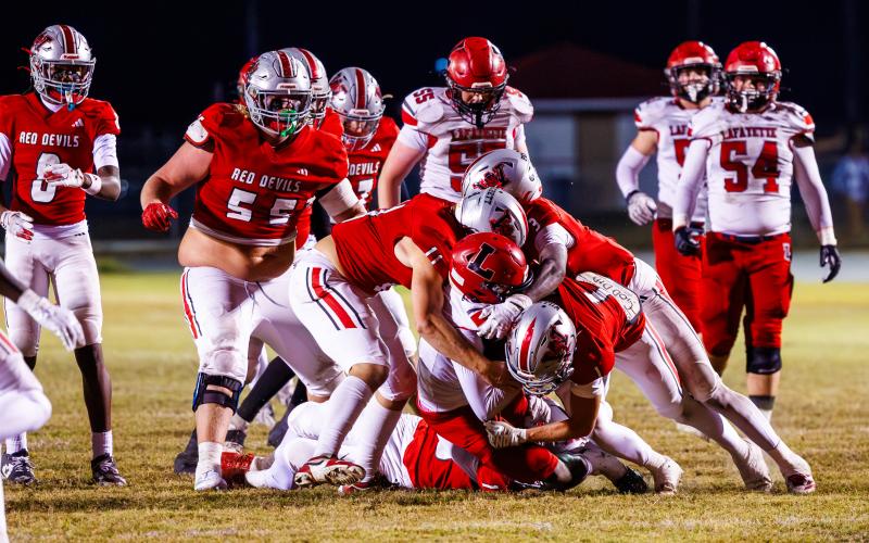 Lafayette quarterback Tywan Williamson gets buried by the Williston defense during Friday night’s Class Rural quarterfinal. (JACK HOWDESHELL/Lake City Reporter)