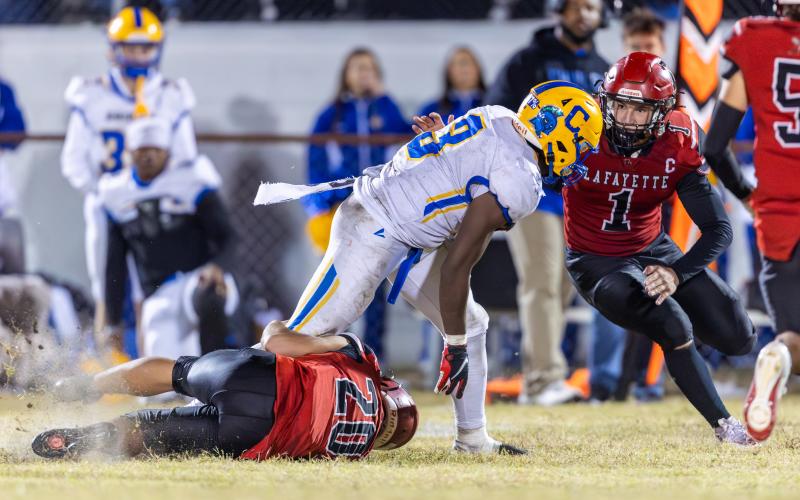 Lafayette linebacker Trevor Byrd (1) comes in to assist Alex Townsend (20) on a tackle against Chipley’s Jakobe McKinnie on Oct. 31. (JACK HOWDESHELL/Lake City Reporter)