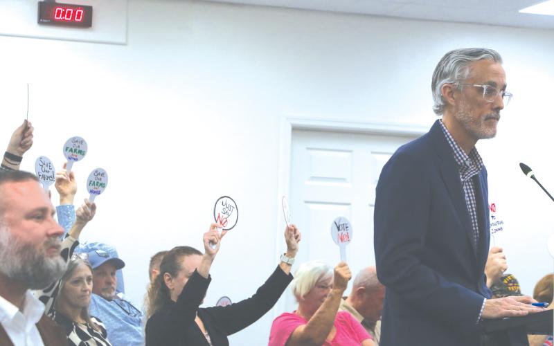 Price Creek LLC attorney Patrick Krechowski (right) addresses the Lake City Council in front of protesting Price Creek residents during Monday’s meeting. (MORGAN MCMULLEN/Lake City Reporter)