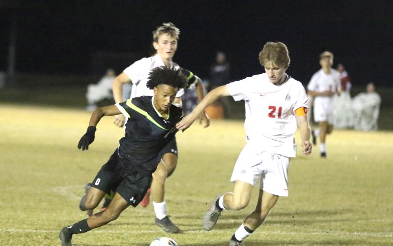 Columbia forward Colyn Weatherspoon is grabbed by Santa Fe defender Mason Kramer during Tuesday's 2-1 loss. (MORGAN MCMULLEN/Lake City Reporter)