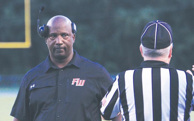 Fort White coach Demetric Jackson stares down a referee during a game last season. (FILE)