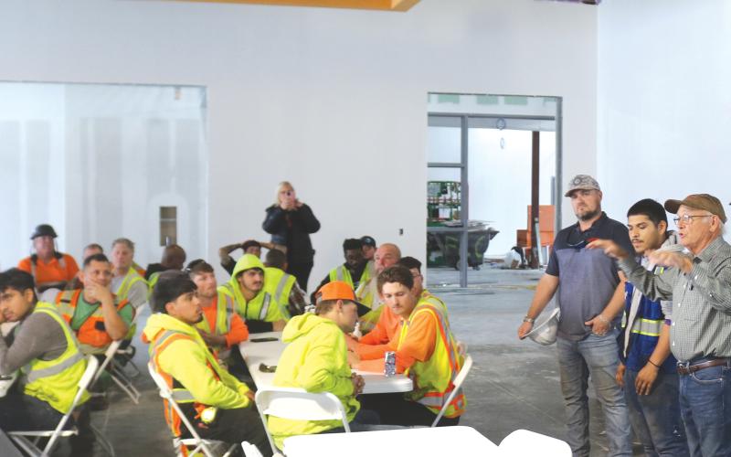 Keith Hudson (right), a Columbia County School Board member, offers construction workers a personal ‘Thank You’ for their work on the new Eastside Elementary during a topping-off ceremony and luncheon at the building on Tuesday morning. (TONY BRITT/Lake City Reporter)