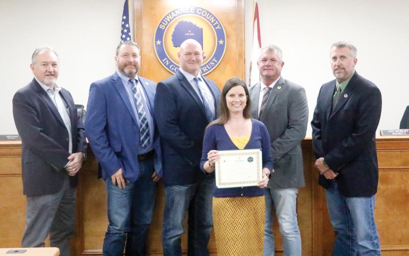 Suwannee County Economic Development Coordinator Charissa Setzer recently earned her Basic Economic Development Certification from the University of South Florida. Setzer was honored for the achievement at Tuesday’s Suwannee County Commission meeting by Economic Development Director Jimmy Norris (from left) and Commissioners Leo Mobley, Don Hale, Franklin White and Travis Land. (JAMIE WACHTER/Lake City Reporter)