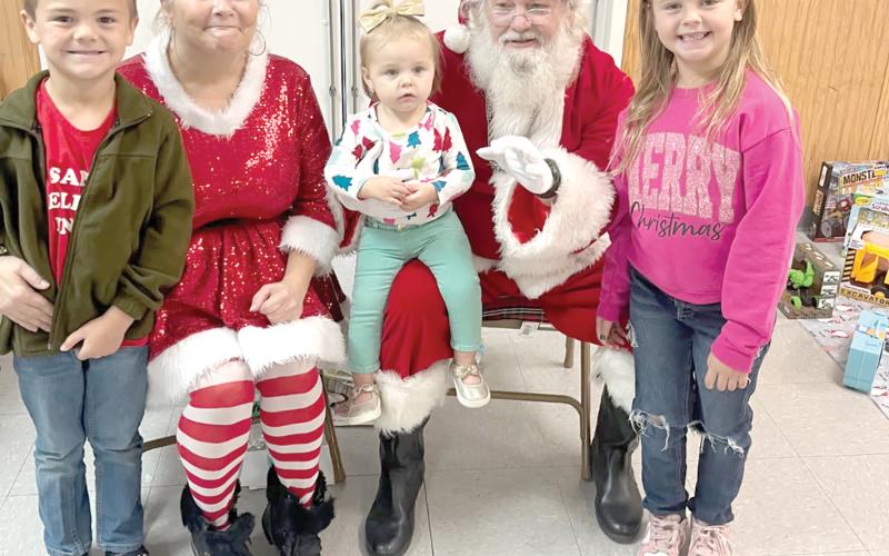 Santa and Mrs. Claus visit with children during the Breakfast with Santa event in Fort White on Saturday. (COURTESY)
