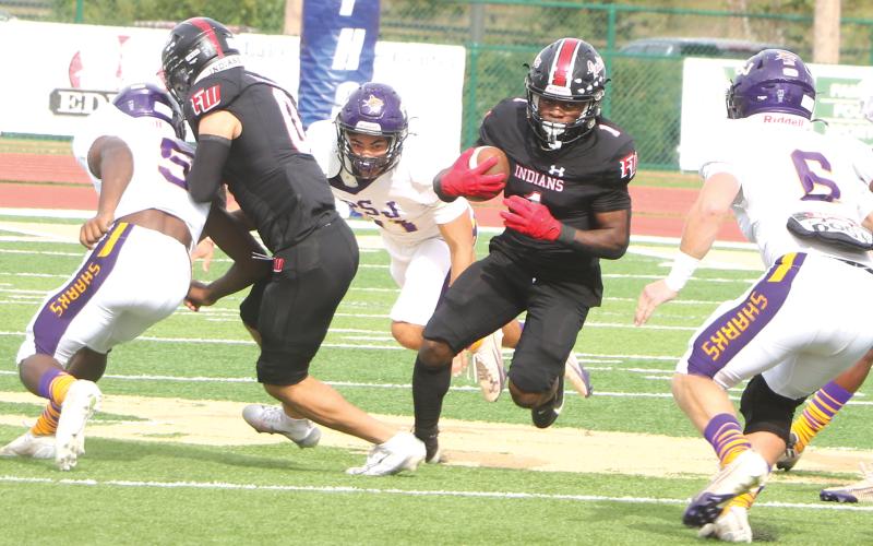 Fort White running back John'l Lawson finds a crease through the Port St. Joe defensive line during the FIT championship on Dec. 5. (MORGAN MCMULLEN/Lake City Reporter)