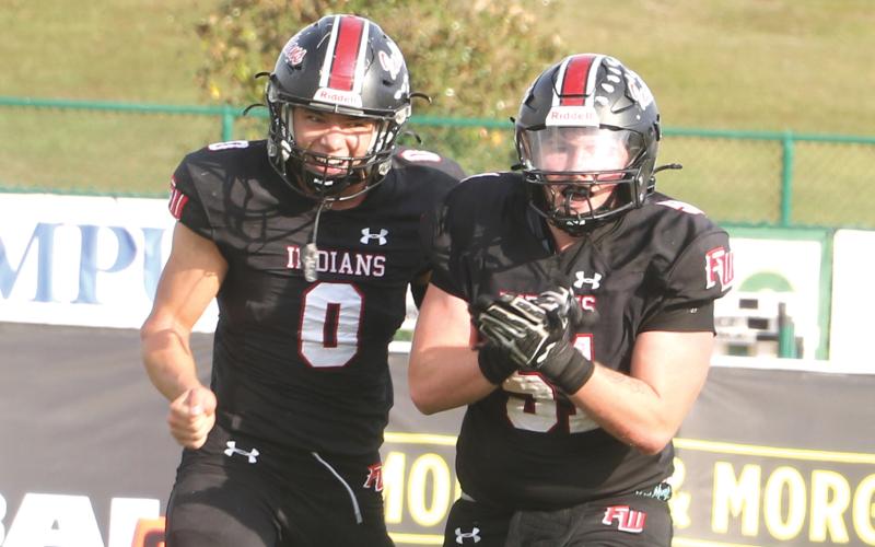 Fort White defensive lineman Ethan Shaw (51) celebrates after his fumble recovery alongside defensive back Ezekiel Powell (0) during the Indians’ 32-29 win over Port St. Joe in the FIT championship on Dec. 5. (MORGAN MCMULLEN/Lake City Reporter)
