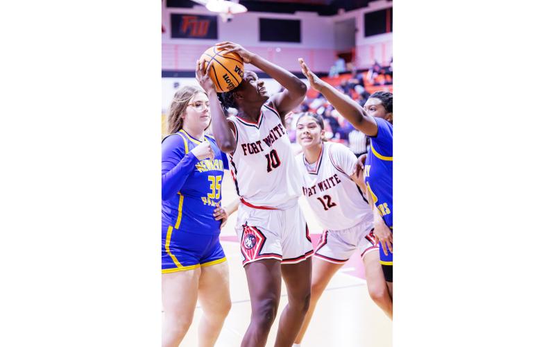 Fort White forward Jahlaya Wilson struggles to get a shot off while surrounded by the Newberry defense on Friday. (JACK HOWDESHELL/Lake City Reporter)