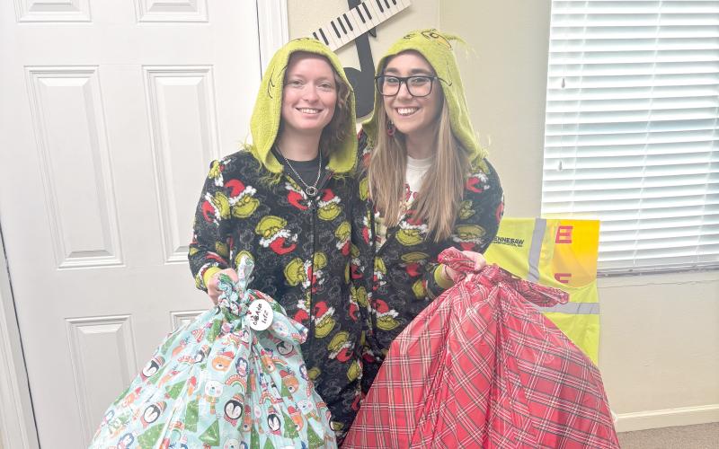 Taylor and Kayli McCathern hold bags of presents that God’s Hidden Angels collected for underprivileged children in Suwannee County. (COURTESY)