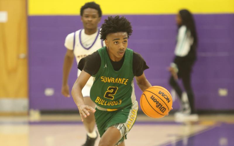 Suwannee guard Jalen Hampton dribbles the ball up the court against Columbia on Dec. 12. (PAUL BUCHANAN/Lake City Reporter)