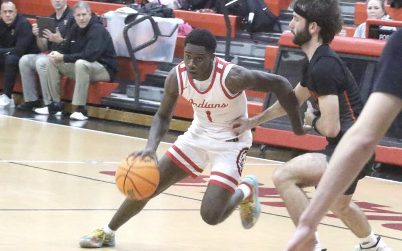 Fort White guard Jayden Jackson dribbles past Trenton forward Nathan Ridgell during Tuesday's 59-34 loss. (MORGAN MCMULLEN/Lake City Reporter)