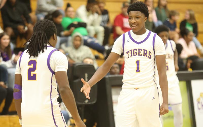 Columbia guards Kadrian Wilson (2) and Shaheed White (1) celebrate during the Tigers' win over Suwannee on Dec. 12. (PAUL BUCHANAN/Lake City Reporter)