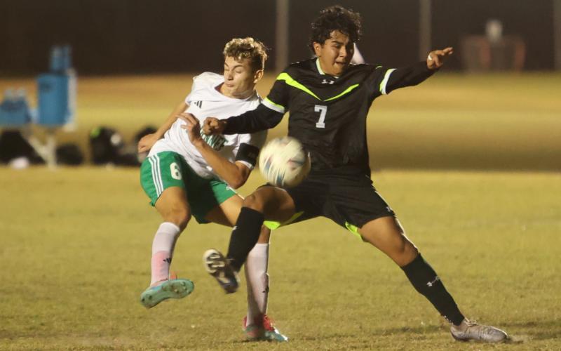 Suwannee's Colt Lee (6) and Columbia's Roger De La Cruz (7) fight for possession for the ball during Monday's match at CYSA. (PAUL BUCHANAN/Lake City Reporter)