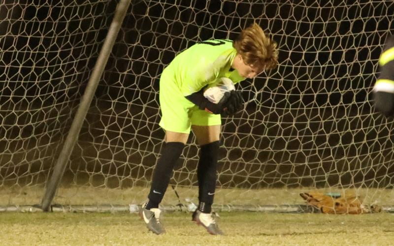 Columbia goalkeeper Logan Wheeldon makes a save against Suwannee on Dec. 1. (PAUL BUCHANAN/Lake City Reporter)