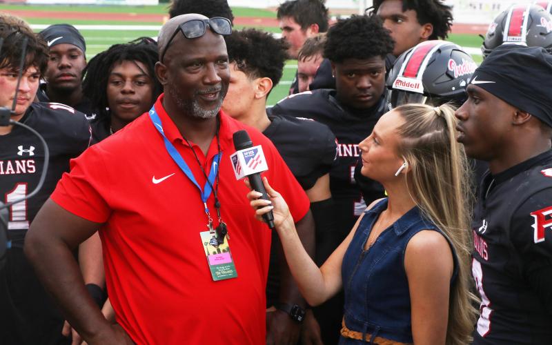 Fort White coach Demetric Jackson is interviewed by a reporter following the Indians’ 32-29 win over Port St. Joe in the FIT championship on Friday. (MORGAN MCMULLEN/Lake City Reporter)