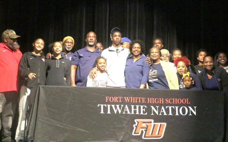Fort White defensive back Jayden Jackson (center) is surrounded by friends and family after his signing day ceremony Thursday. (MORGAN MCMULLEN/Lake City Reporter)