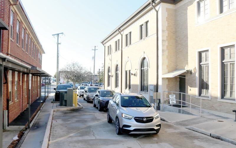 A line of vehicles sit in the drive-through lane at the Columbia County Tax Collector’s Office Monday. More than 300 people were served by the office Monday on one of the busiest days of the year. (TONY BRITT/Lake City Reporter)