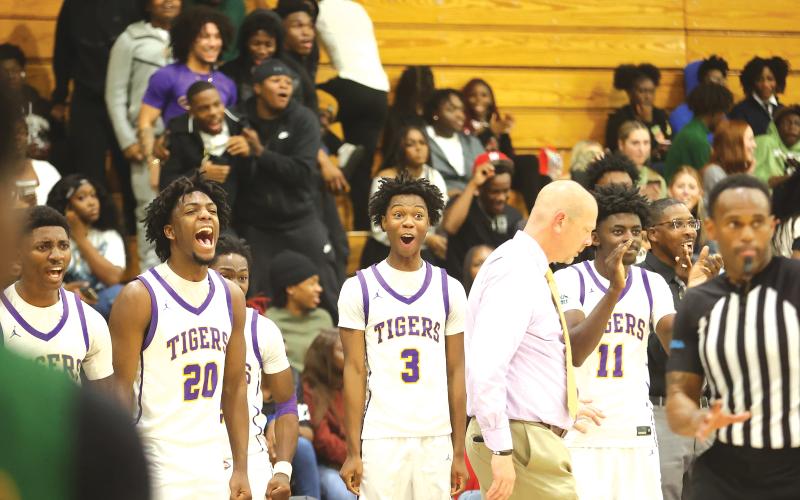 The Columbia bench, alongside coach Steve Faulkner, reacts to a play during the Tigers’ 72-45 win over Suwannee on Dec. 12. CHS wrapped up its weekend at the Holiday Hoopfest in Fort Myers with a 2-1 record, beating Gateway Charter and Mater Academy Charter. (PAUL BUCHANAN/Lake City Reporter)
