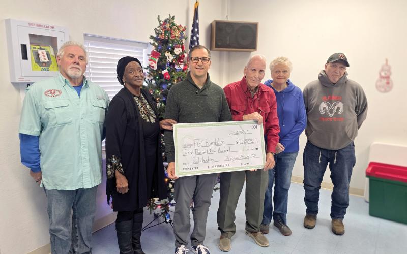 The Wellborn Community Association donated earlier this month toward a scholarship fund with the Foundation at Florida Gateway College to help students pursue Career and Technical Education degrees and certificates. Presenting the check to FGC Foundation Executive Director Lee Pinchouck were Sherm Stanley (from left), Fran Martin, Pinchouck, Bob Huffman, Pam Mikitta and Pedro Faria. (MONJA SLATER/Lake City Reporter)