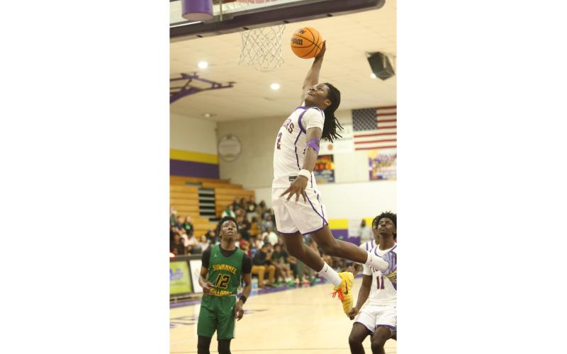 Columbia guard Kadrian Wilson flies through the lane for a dunk against Suwannee on Friday. (PAUL BUCHANAN/Lake City Reporter)