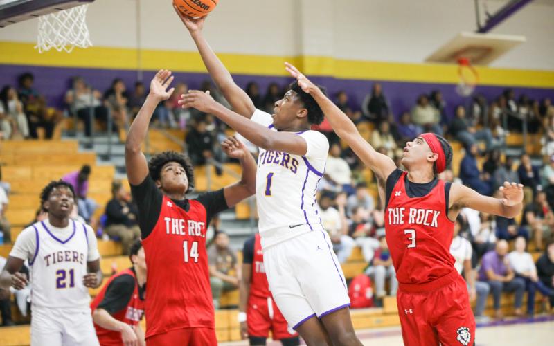 Columbia guard Shaheed White drives between The Rock defense for a layup on Tuesday. (BRENT KUYKENDALL/Lake City Reporter)