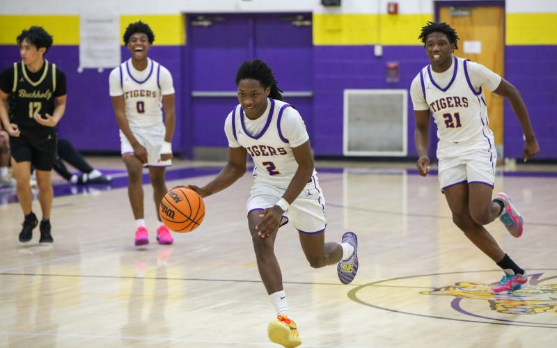 Columbia guard Kadrian Willson dribbles on a fast break for a game-sealing dunk against Buchholz on Tuesday. (BRENT KUYKENDALL/Lake City Reporter)