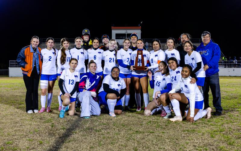 The Branford girls soccer team shows off the District 2-2A championship trophy after defeating Dixie County 3-1 on Monday. (JACK HOWDESHELL/Lake City Reporter)