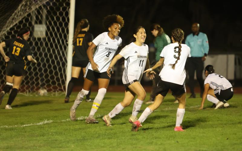 Suwannee midfielder Briseida Angeles (11) celebrates with Alaira Handy (8) and Victoria Cavazos (9) after scoring the go-ahead goal against Columbia on Friday. (PAUL BUCHANAN/Lake City Reporter)
