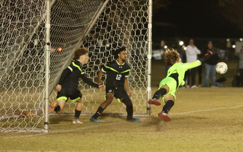 Columbia goalkeeper Logan Wheeldon makes a diving save against Suwannee on Dec. 1. (PAUL BUCHANAN/Lake City Reporter)