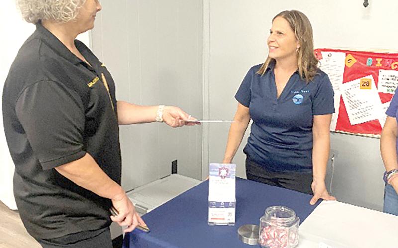 Barbara Etter, community services coordinator with Living Hope, speaks to Columbia County Chief Deputy Katina Dicks at a local event. (COURTESY)