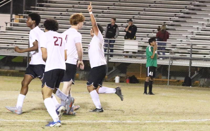 Suwannee striker Hector Velasquez (46) stands disappointed as Florida High’s Manuel Hernandez celebrates teammate Keenen Jeune’s game-winning goal in double overtime of Friday’s District 2-3A semifinal. (MORGAN MCMULLEN/Lake City Reporter)