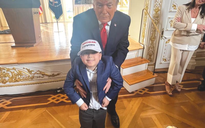 Rep. Chuck Brannan’s son, Rafe, is held by President Donald Trump during Friday’s ceremony. (COURTESY)