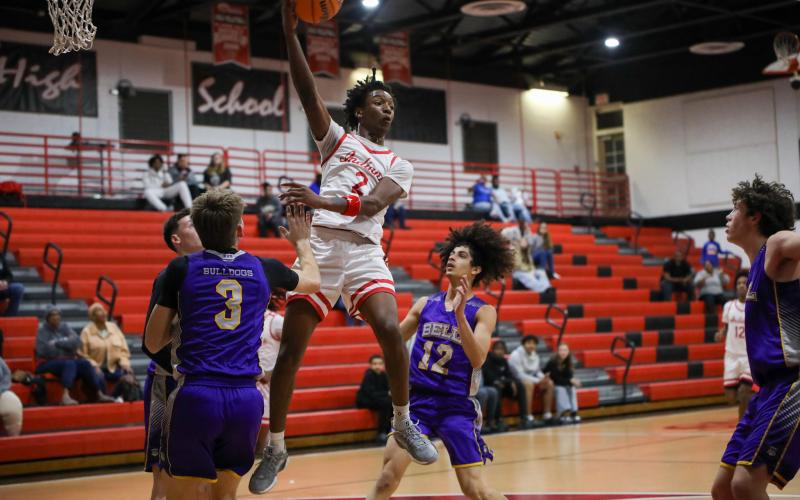Fort White guard Desean Lally throws a pass during Tuesday's District 6-R quarterfinal against Bell. (BRENT KUYKENDALL/Lake City Reporter)