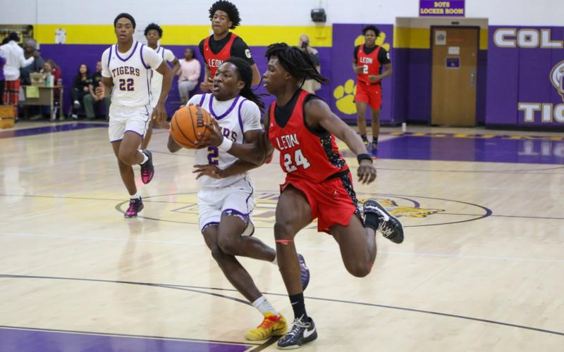 Columbia guard Kadrian Wilson drives to the basket while tightly guarded by Leon forward Keon Green during the District 2-5A semifinals on Feb. 5. (BRENT KUYKENDALL/Lake City Reporter)