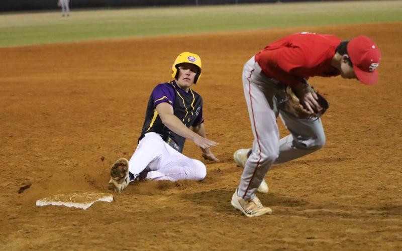 Columbia pitcher Tison McCray slides safely into third base against Santa Fe on Monday. (BRENT KUYKENDALL/Lake City Reporter)