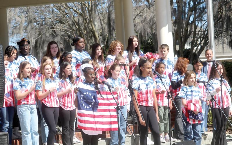 Richardson Sixth Grade Academy students from the school’s chorus and theatre program sing a song during a skit at the local 250th Birthday Party for America kickoff celebration on Tuesday morning. The event was attended by more than 200 people. (TONY BRITT/Lake City Reporter)