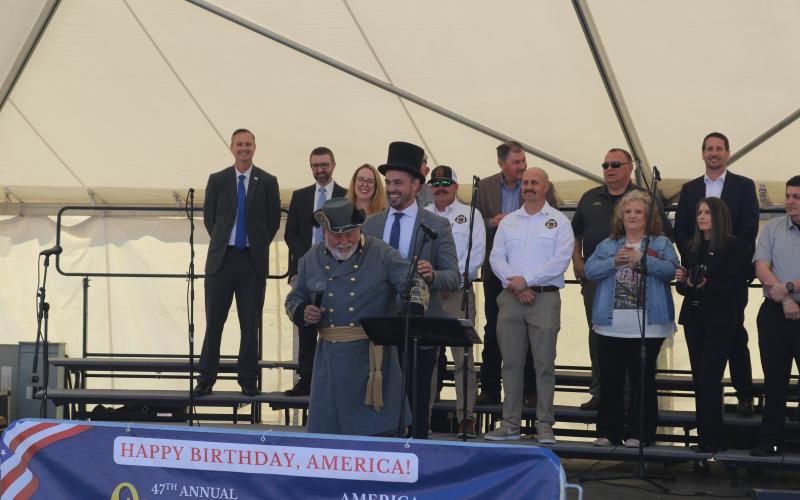 Lake City Mayor Noah Walker and Blue-Grey Army Commanding General Tony Buzzella (center) share a laugh during the opening ceremony of the 47th annual Olustee Festival on the banks of Lake DeSoto at Wilson Park. (TONY BRITT/Lake City Reporter)