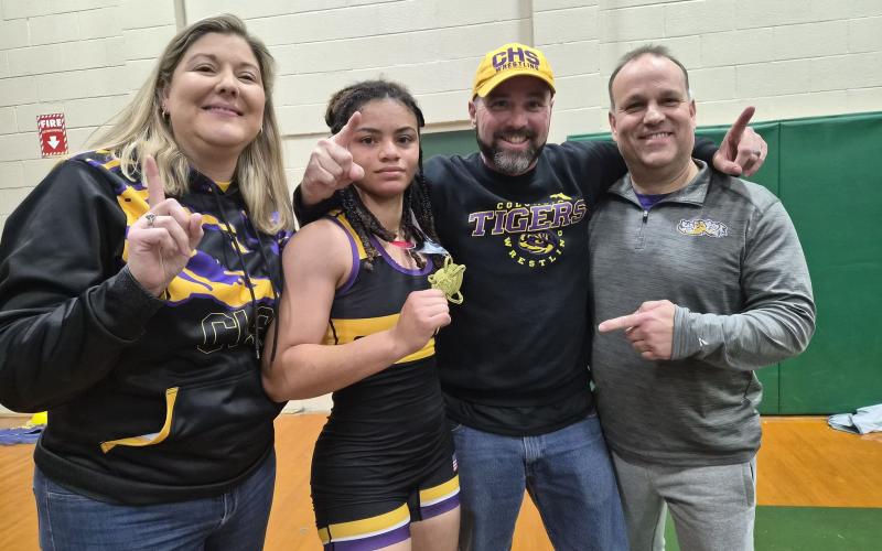 Columbia wrestler Bella Guerrier-Lajoir shows off her first-place medal after winning the 140 class at the Lady Trojan Invitational on Saturday. (COURTESY)