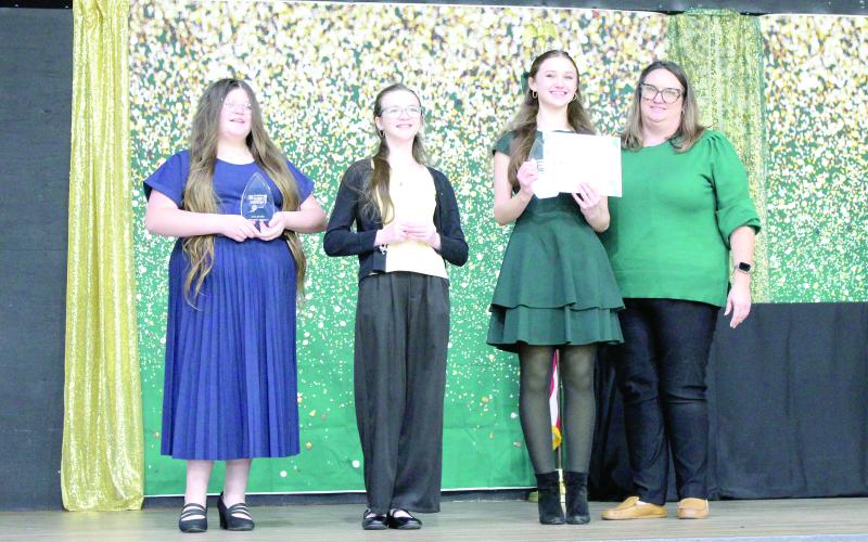 Sixth grade winners in the Suwannee County 4-H Public Speaking Contest were Kendell Wynn, third place (from left); Mikayla Richardson, second place; Kellyn Crocker, first place; and Katie Jones, 4-H Extension Agent. (COURTESY)