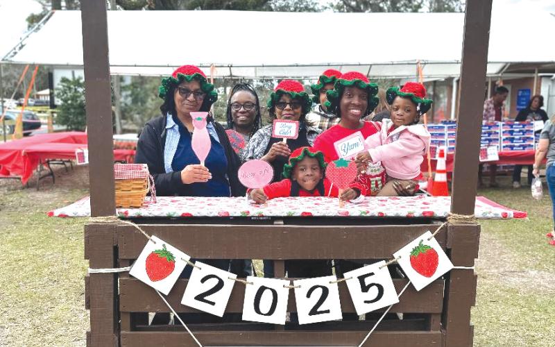 A family poses for a pic at the photo station during last year’s Live Oak Strawberry Festival. This year’s festival begins at 10 a.m. Saturday at the Suwannee County Fairgrounds in Live Oak. (COURTESY)