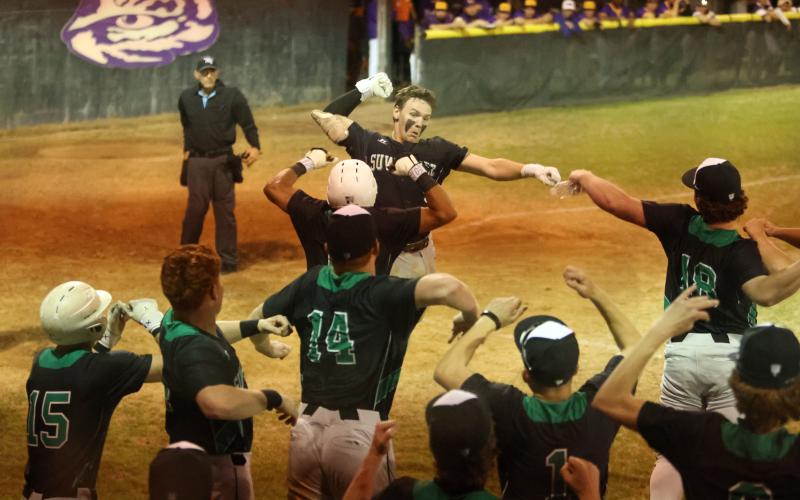 Suwannee catcher Jace Moran celebrates with teammates after hitting a two-run home run against Columbia on Wednesday. (PAUL BUCHANAN/Lake City Reporter)